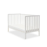 White cot bed, in day bed mode for with 1 side removed.
