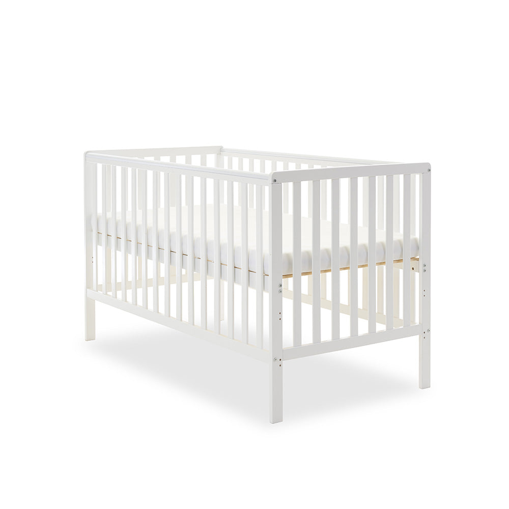 White cot bed, with rails on 4 sides, teething rail & base on heighest setting.