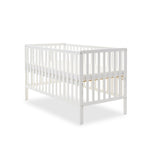 White cot bed, with rails on 4 sides, teething rail & base on heighest setting.