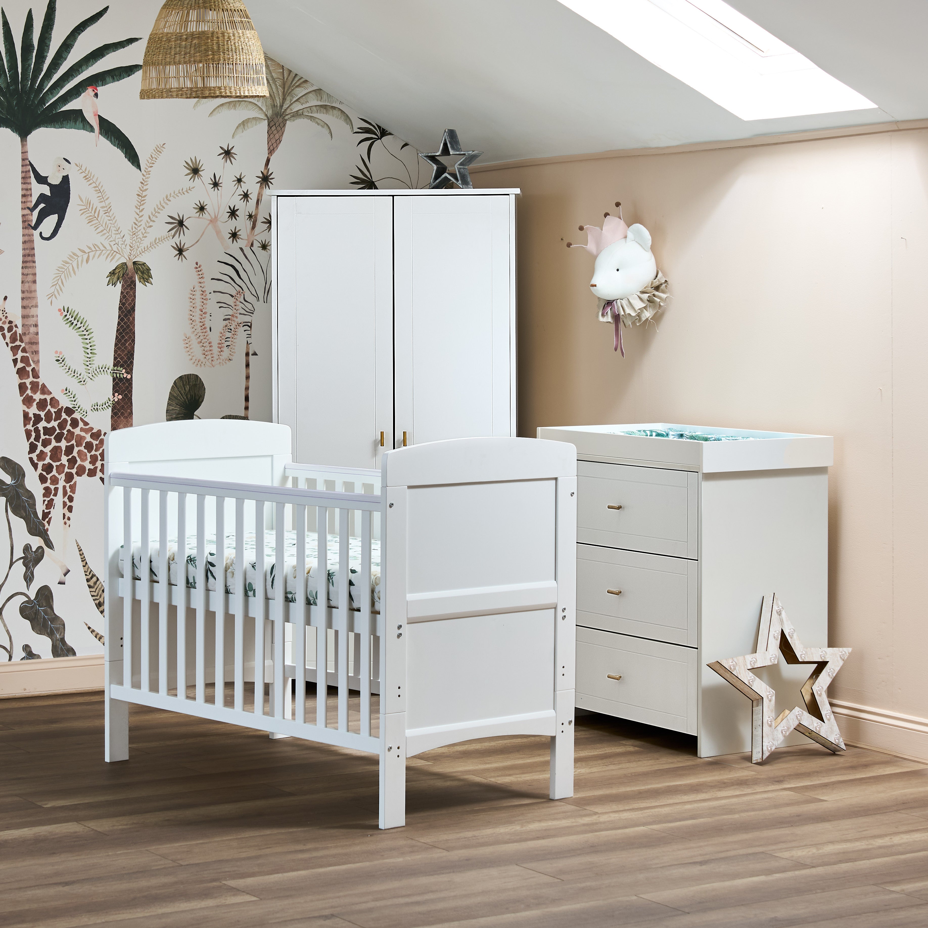 White Mini Cot Bed with solid sides, closed changing unit with 3 drawers Changing top fitted on & matching double wardrobe with gold T bar handles.