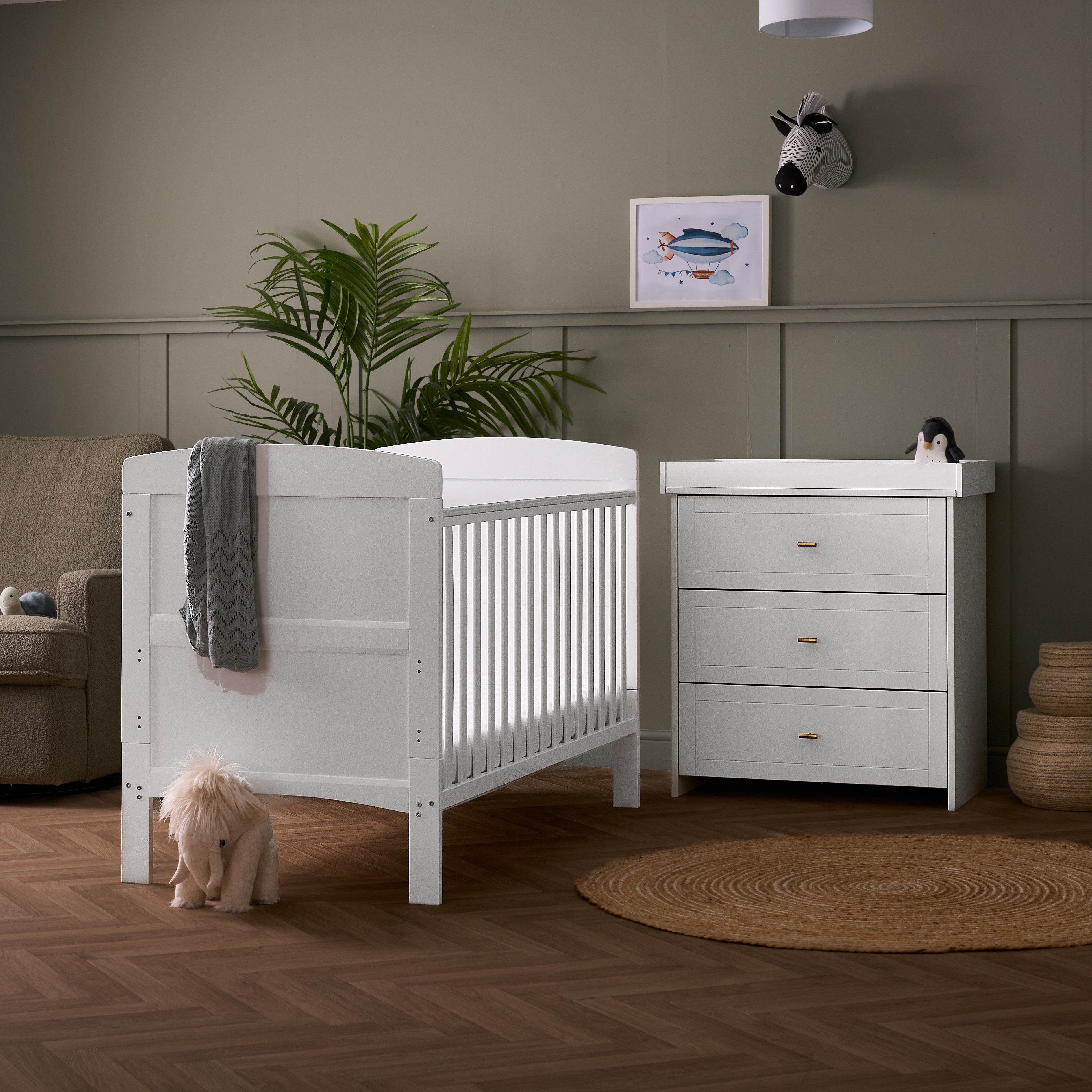 white cot bed & matching closed changing unit with 3 drawers & gold t bar handles.