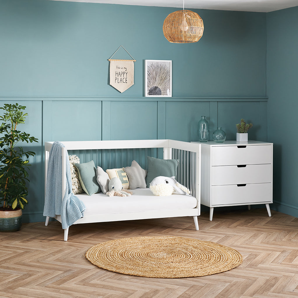 Scandi style acrylic cot bed in day bed mode with front side removed.