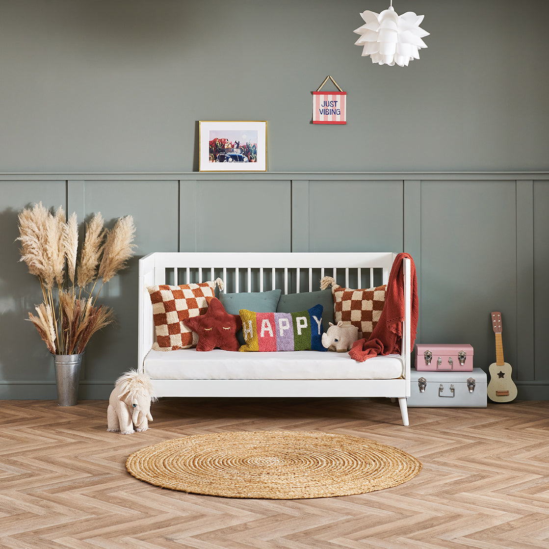 Cot bed that converts into day bed by removing one side