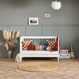 Cot bed that converts into day bed by removing one side
