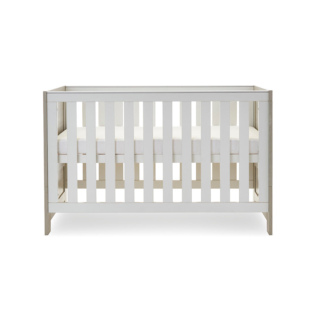cot bed with solid ends, base at middle setting.