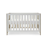 cot bed with solid ends, base at middle setting.
