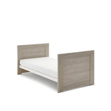 Mini Cot Bed converted into a toddler bed with solid sides.