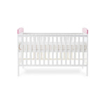 Side of cot bed, with base on new born setting, pink trim on ends.