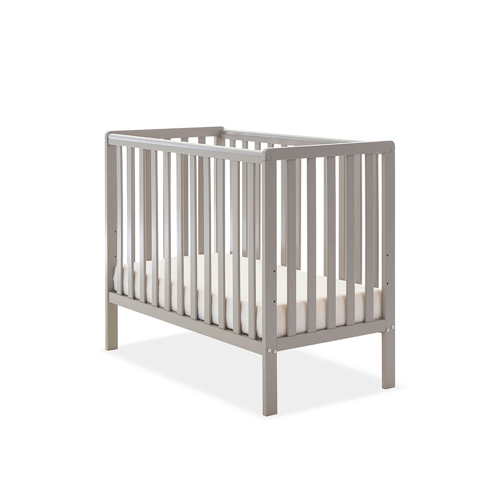 Compact Cot with base on the lwest setting, teething rail on 2 sides, rails on all 4 sides.