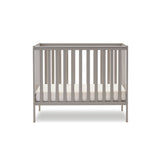 Compact Cot with teething rails on sides, rails on all 4 sides. base on the lowest setting.
