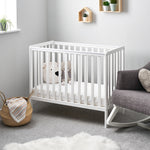 Compact cot with rails on all 4 sides with teething rails.