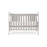 Mini cot bed with solid ends, curved tops, teething rails on the side rails & base on the middle setting.