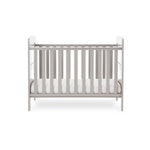Mini Cot Bed with base on the lowest setting, solid ends with curved top & teething rails on top sides.