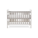 Mini cot bed with solid ends, curved top & teething rail fitted on rails. base on the new born setting