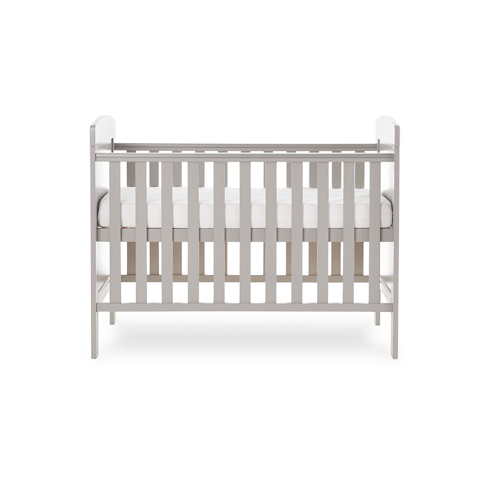 Mini Cot Bed with solid ends curved tops, teething rails on the side rails & base on the new born setting.