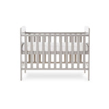 Mini Cot Bed with solid ends curved tops, teething rails on the side rails & base on the new born setting.