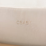 Bedside crib close up of woven obaby logo