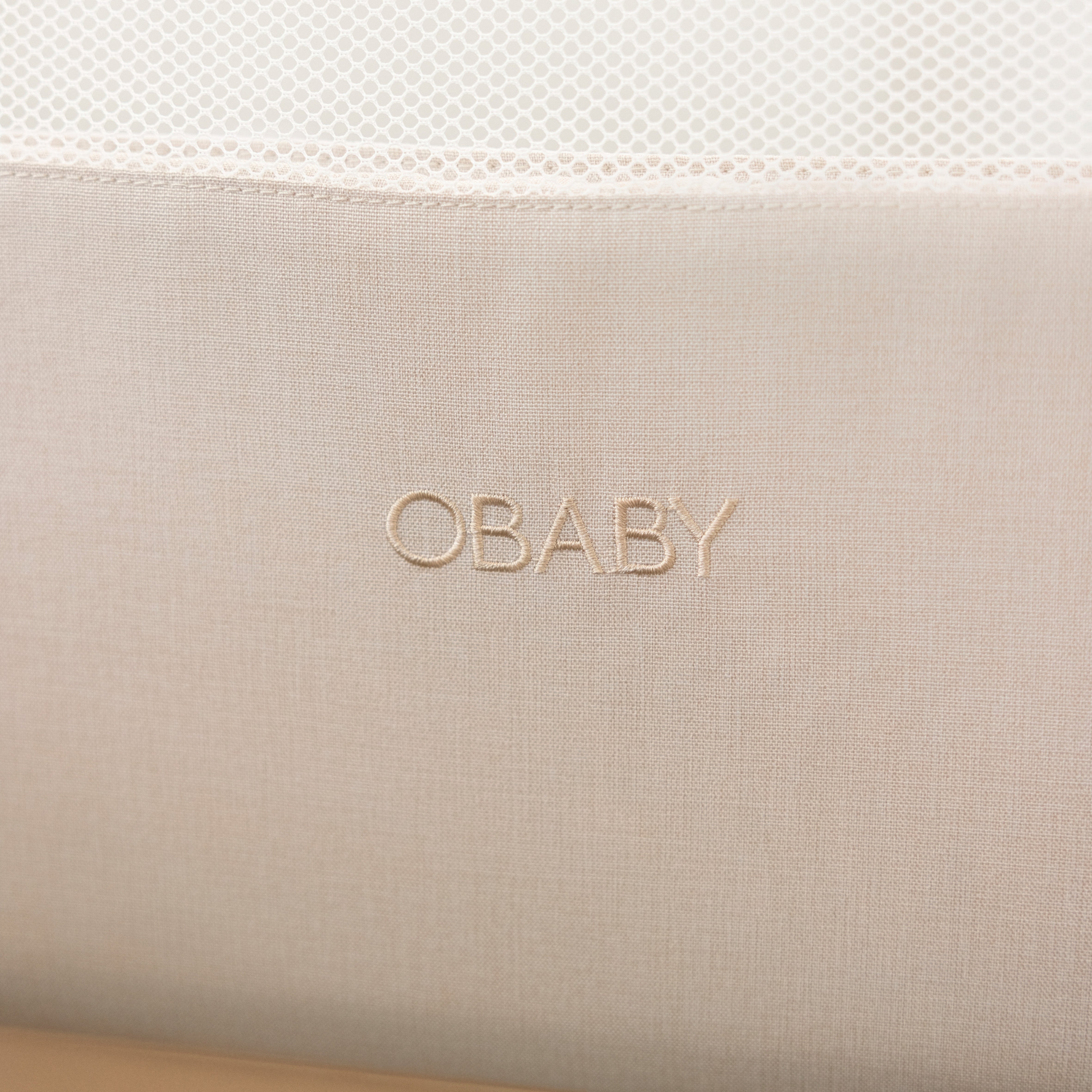 Bedside crib close up of woven obaby logo