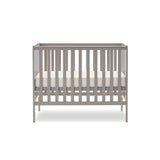 Compact cot with teething rails with open railed ends, base on the middle setting.