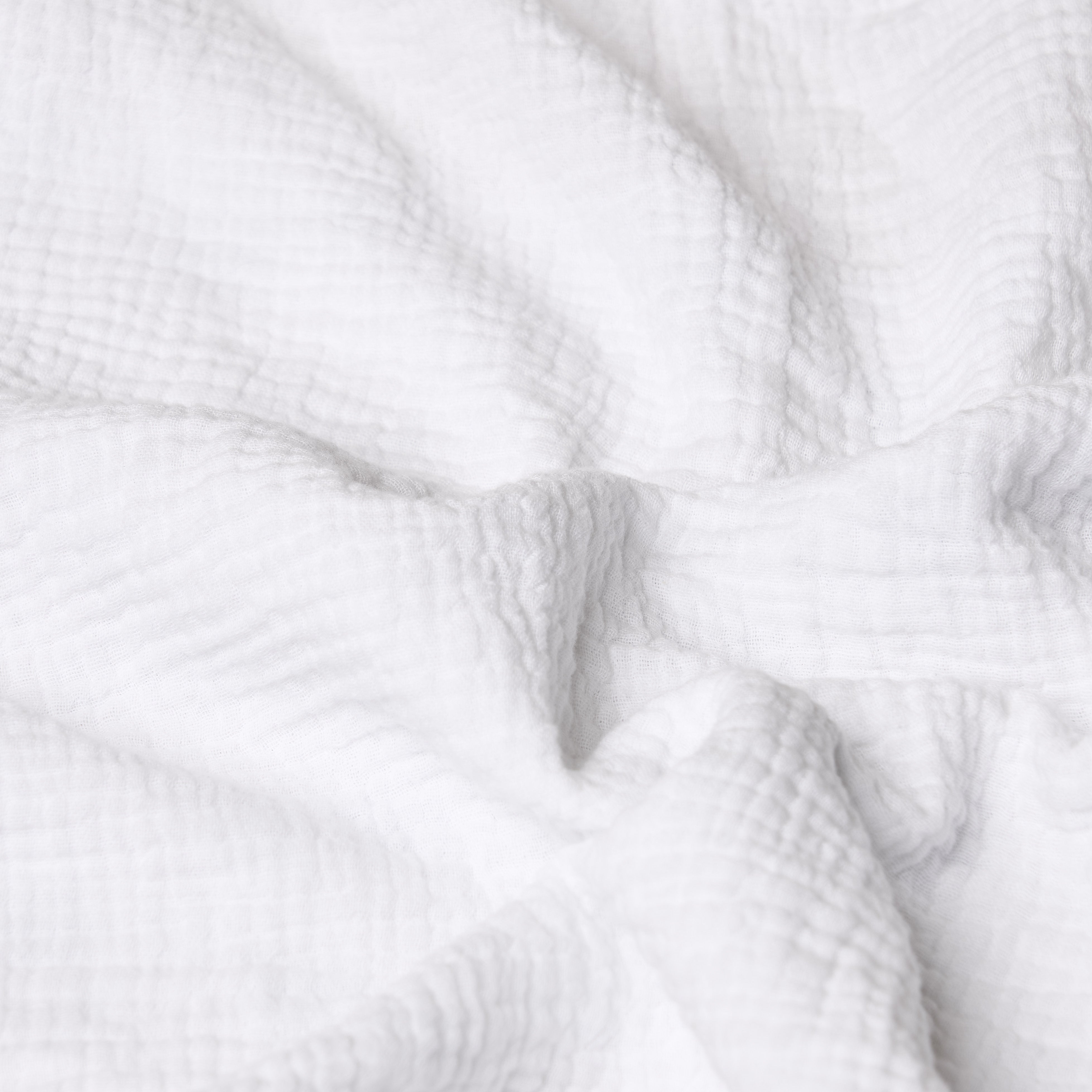 Close-up of white textured muslin fabric