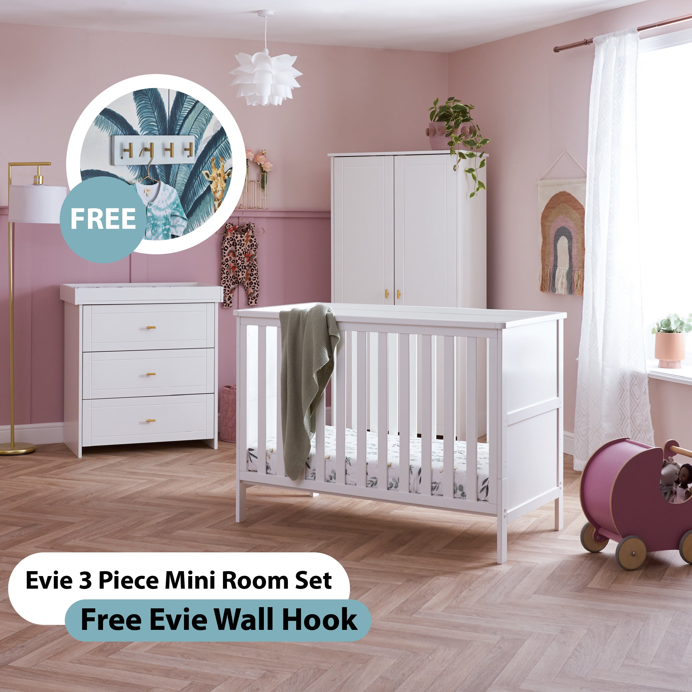 Nursery room set with white mini cot bed, changing with 3 drawer & trim around the edge and wardobe  all finished off with godl 'T'bar handles, FREE wall hooks on a pink wall.