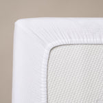 corner of fitted sheet, showing elasticated edge 