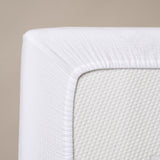 corner of fitted sheet, showing elasticated edge 