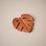 Leaf shaped teether in burnt orange colour