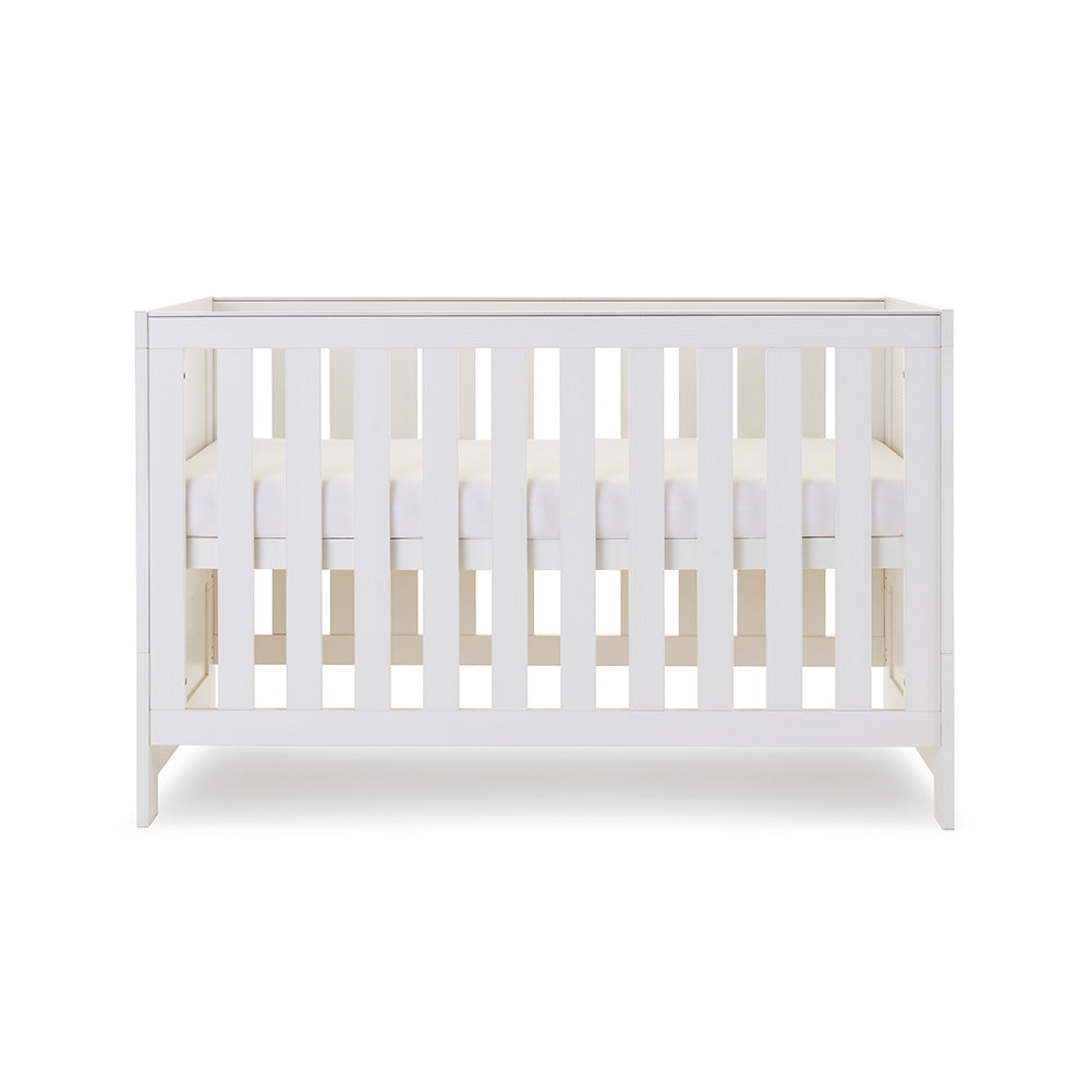 Mini Cot Bed with solid sides, base at middle setting. 