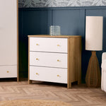 3 drawer changing unit with oak sides & white drawer fronts finished off with gold round handles, baby changing top removed, so ideal for lifetime storage.