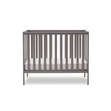 compact cot with rails on all 4 sides, base at the lowest setting.