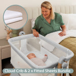Grey Bedside crib with wood effect frame. mesh sides, with sleeping baby in crib & mum looking on from her own bed & mini shot of muslin fitted sheet.