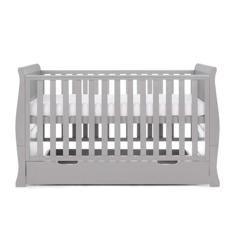 Sleigh Cot Bed, with curved edges, solid ends, side rails have teething rails . Base is on new born setting. 
