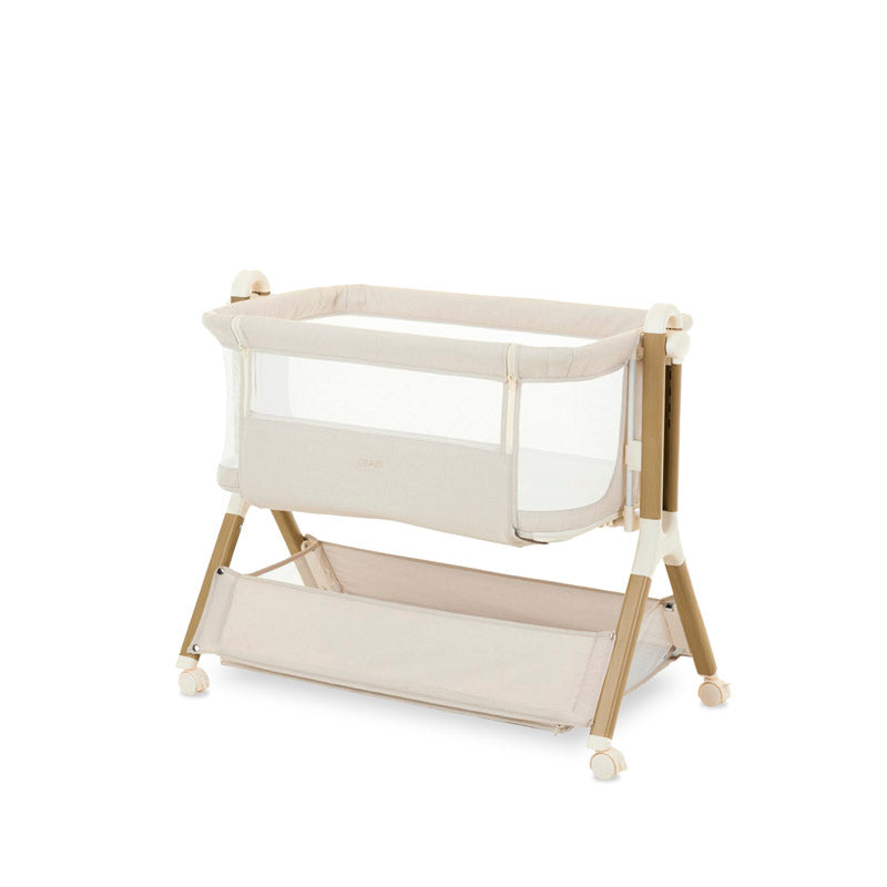 bedside crib on highest setting, oatmeal fabric with mesh sides, parent side has zipped panel that can be opened for easy access to the baby. wood effect frame & storage basket underneath. Caster wheels to move into position easily. 
