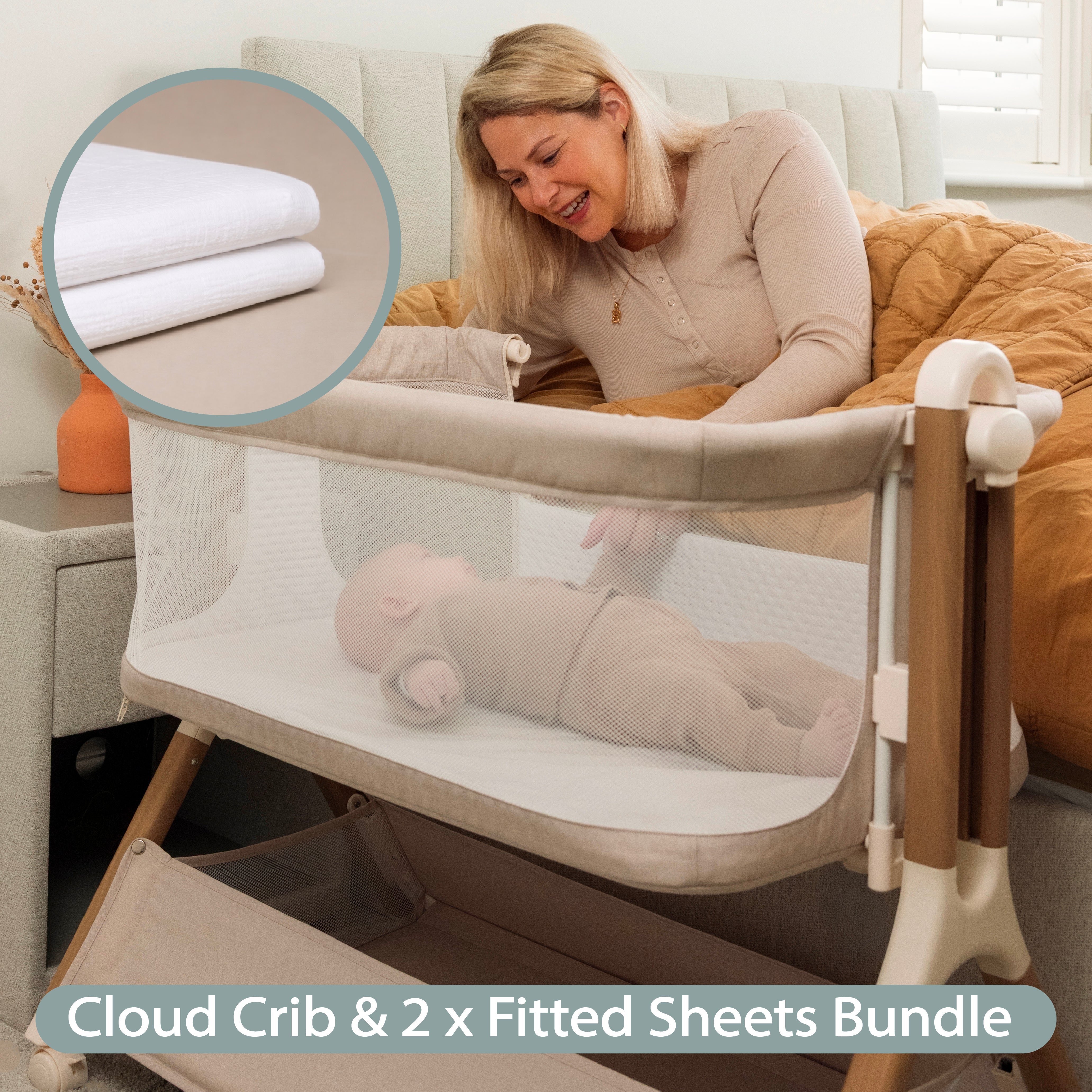 Oatmeal Bedside crib with wood effect frame. mesh sides, with sleeping baby in crib & mum looking on from her own bed & mini shot of muslin fitted sheet.