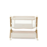 bedside crib on Tallest setting, oatmeal fabric with mesh sides, parent side has zipped panel that can be opened for easy access to the baby. wood effect frame & storage basket underneath. Caster wheels to move into position easily. 