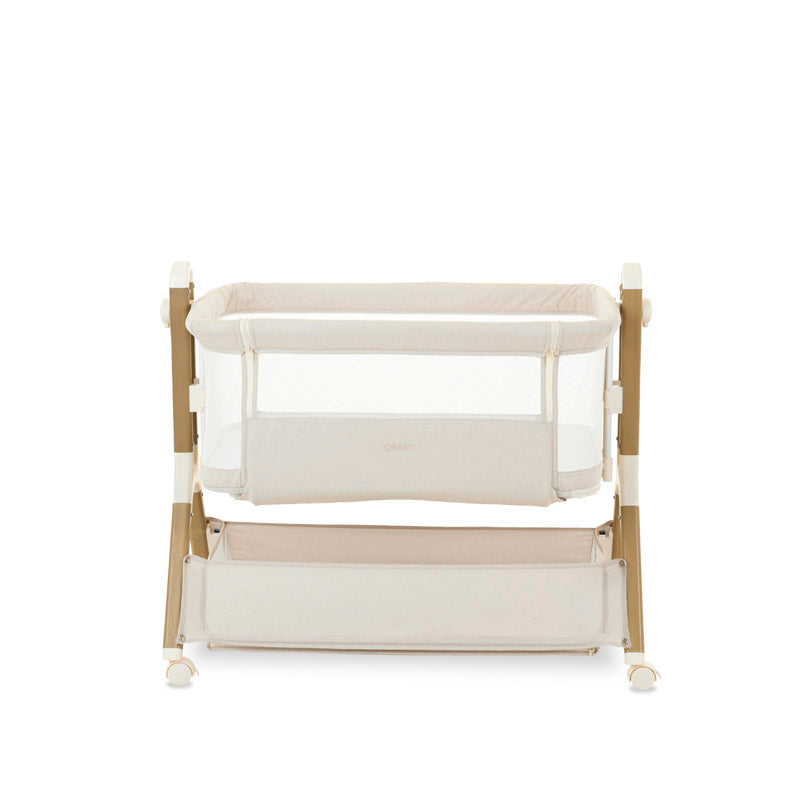 bedside crib on middle setting, oatmeal fabric with mesh sides, parent side has zipped panel that can be opened for easy access to the baby. wood effect frame & storage basket underneath. Caster wheels to move into position easily. 