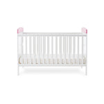 Cot Bed with base on lowest setting, solid ends with pink trim. 