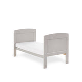 Mini cot bed with solid ends & curved tops converted into a toddler bed by removing the sides & splitting the ends down. 
