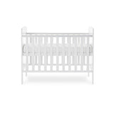 Mini Cot Bed with teething rails on the side, solid ends with curved top. Base on new born setting.