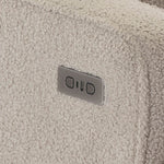 Close-up of a textured Teddy Truffle Fabric surface with USB/c charging port next to recline buttons on chair armrest. 