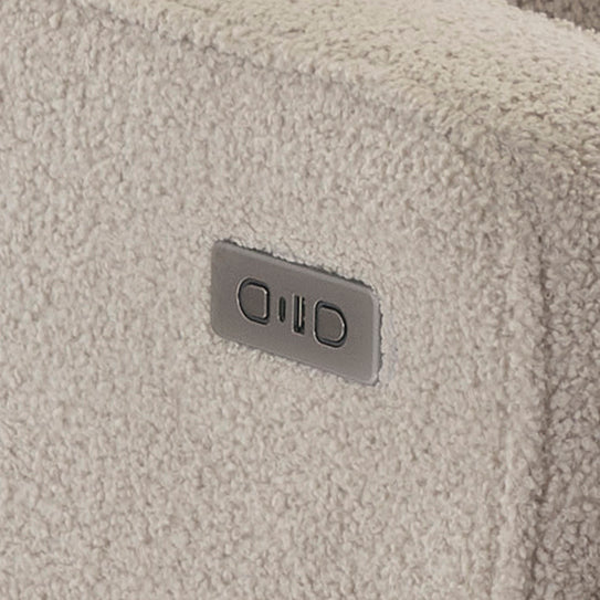 Close-up of a textured Teddy Truffle Fabric surface with USB/c charging port next to recline buttons on chair armrest. 