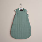 Turquoise muslin baby sleeping bag with press stud around the shoulder & arms 