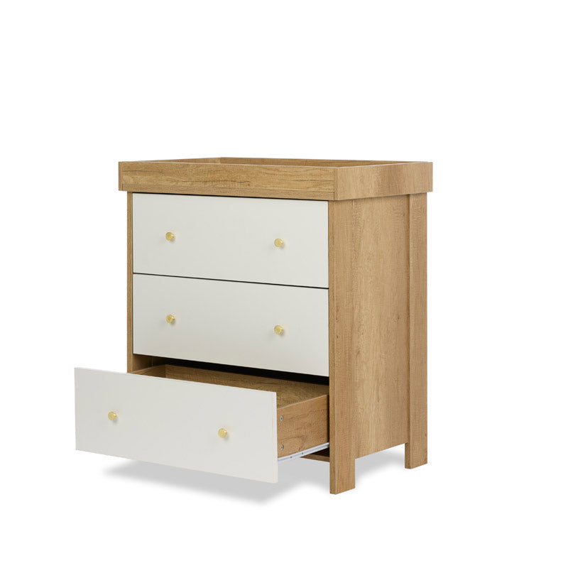 3 drawer changing unit with oak sides & white drawer fronts finsihed off with gold round handles, baby changing top fitted but can be removed, so ideal for lifetime storage. Bottom drawer open, showing drawer runners. 