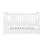Sleigh cot bed with curved edges, solid  ends, teething rails fitted on the sides, base on the middle setting, under drawer included with cut out open handles. 