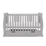 sleigh cot bed with curved edges, solid ends & teething rails on the side rails, base set on the middle level. 