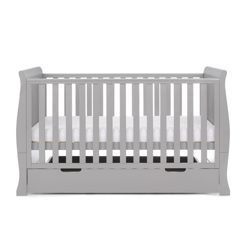 sleigh cot bed with curved edges, solid ends & teething rails on the side rails, base set on the middle level. 