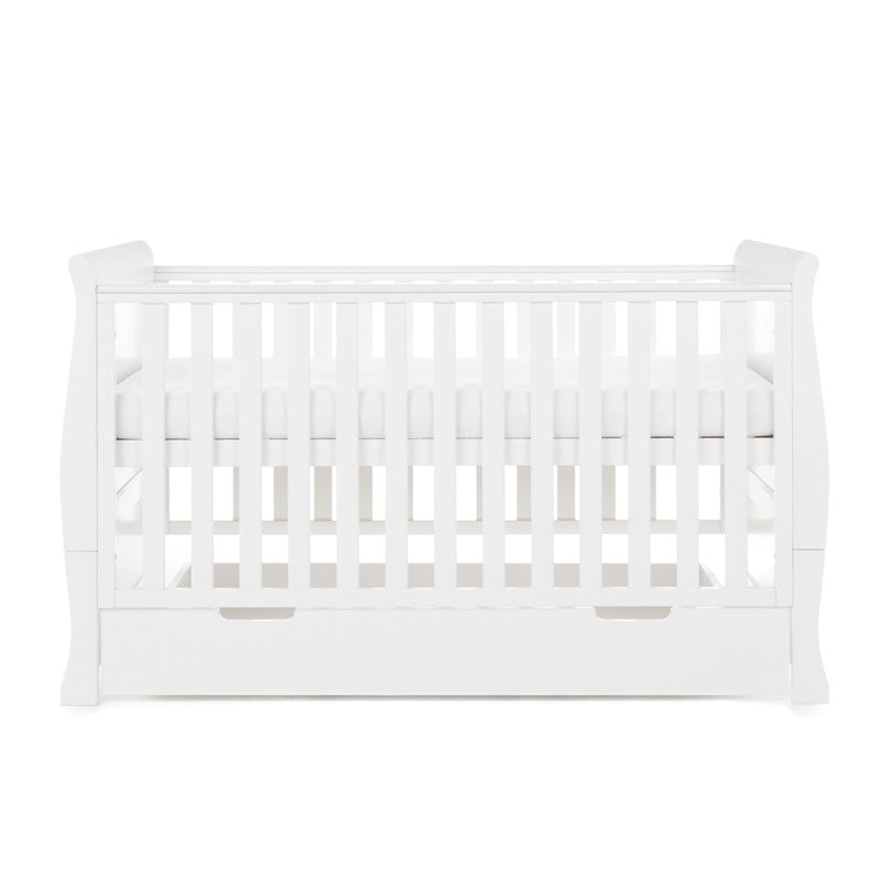 Sleigh Cot Bed with curved edges, solid ends, teething rail on the sides, base on new born setting. Under drawer included with cut out handles. 