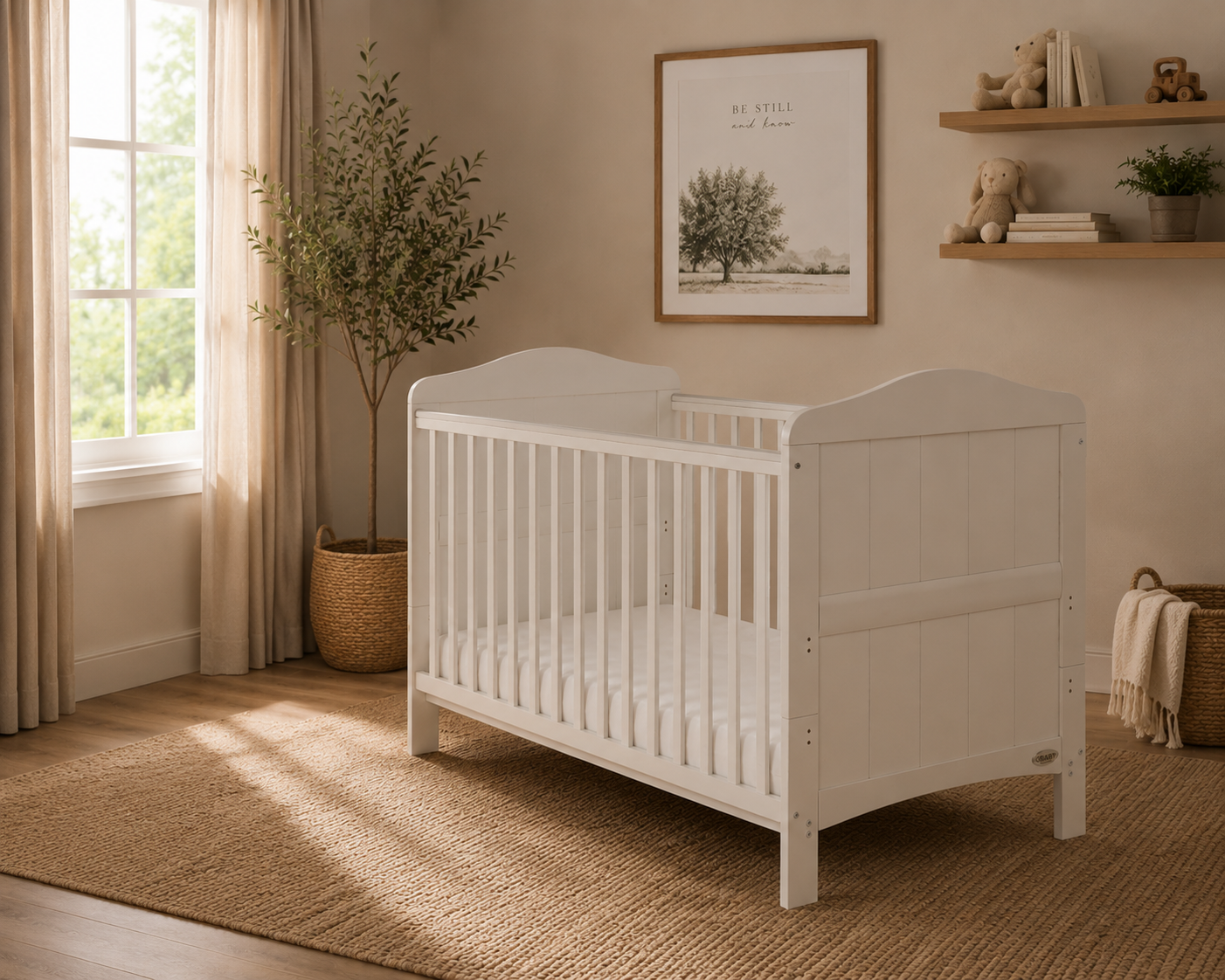 white cot  bed, with curved foot & head end. Teething rail on the rails. 