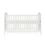 White Cot Bed with base on its new born setting, sides rails have teething rails, ends finished with curved tops 